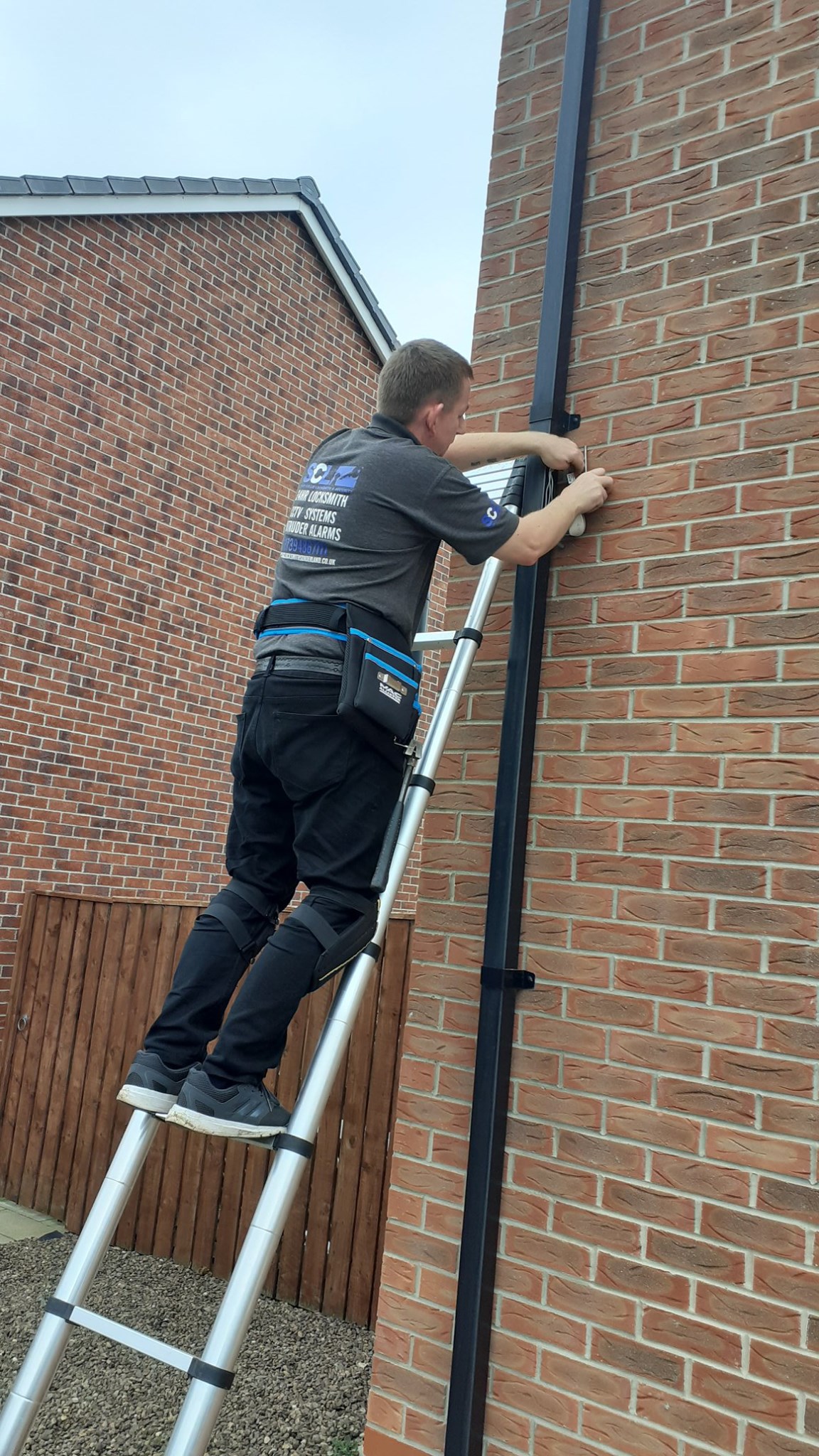 SCL Locksmith technician installing a security camera on a residential property. Expert CCTV installation services for home security